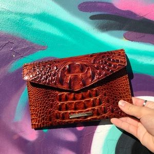 Reddish alligator print Brahmin clutch